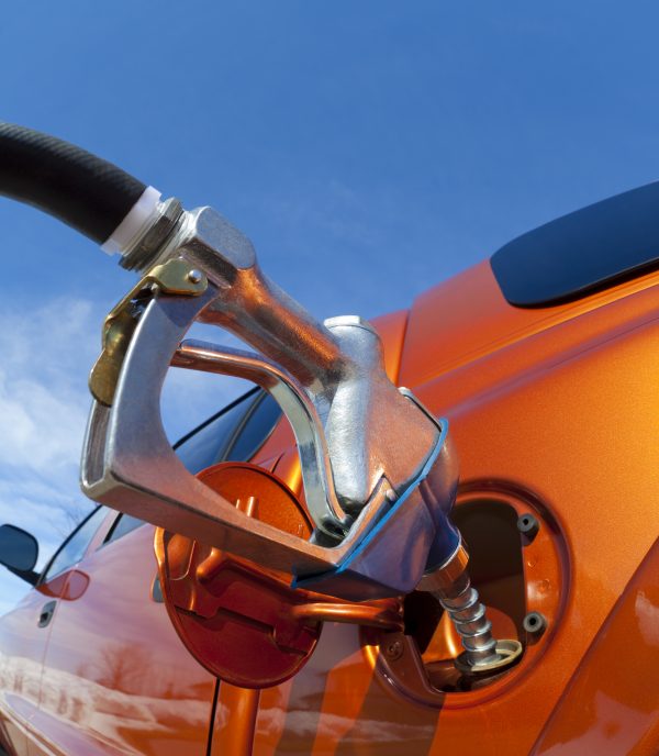 gas pump filling up orange truck