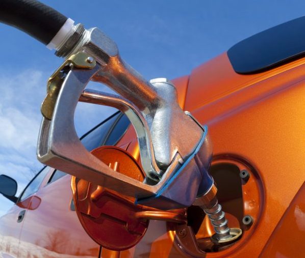 gas pump filling up orange truck