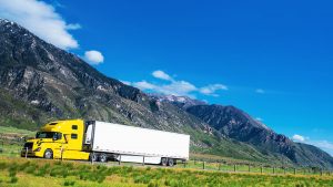 Semi truck driving through mountains