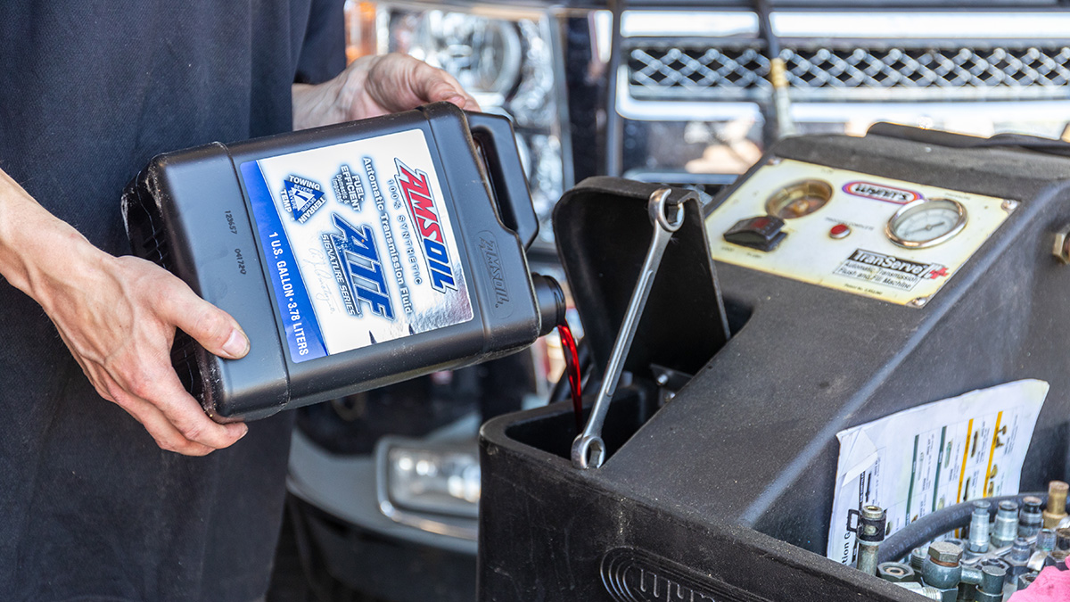 Adding transmission fluid to flush machine.