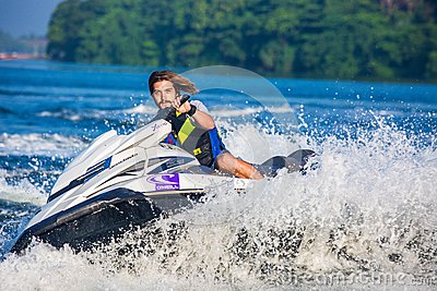 man safety vest riding personal watercraft daytime