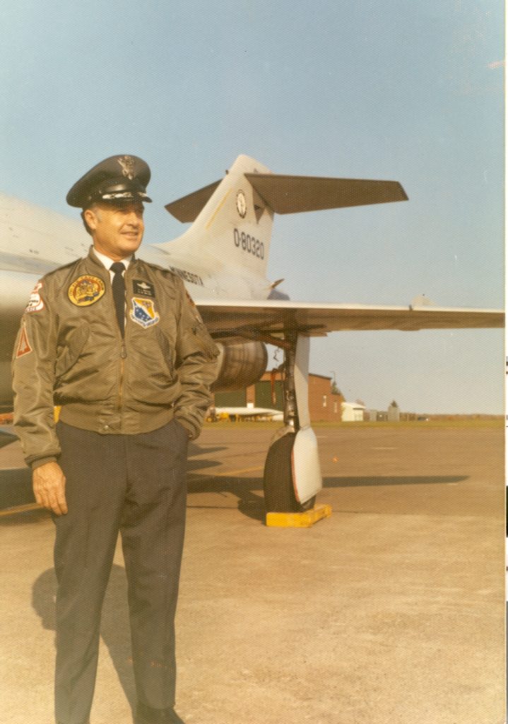 Al Amatuzio in uniform beside a fighter jet