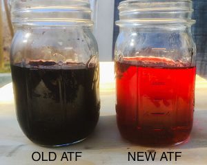 Used transmission fluid that is dark brown and new transmission fluid that is reddish and opaque. 
