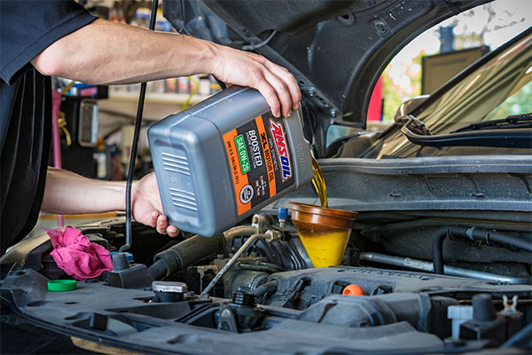 Adding AMSOIL XL Synthetic Motor Oil to engine