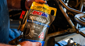 AMSOIL SEVERE GEAR is used by a driver at an off-road racing event.