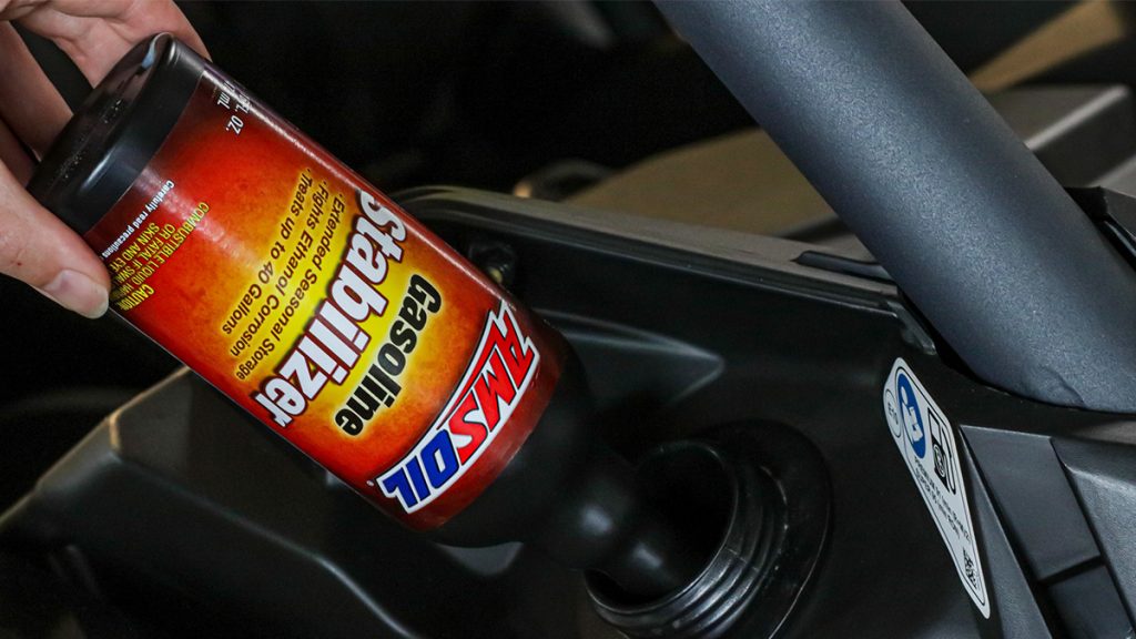 AMSOIL Gasoline Stabilizer is poured into an UTV gas tank.