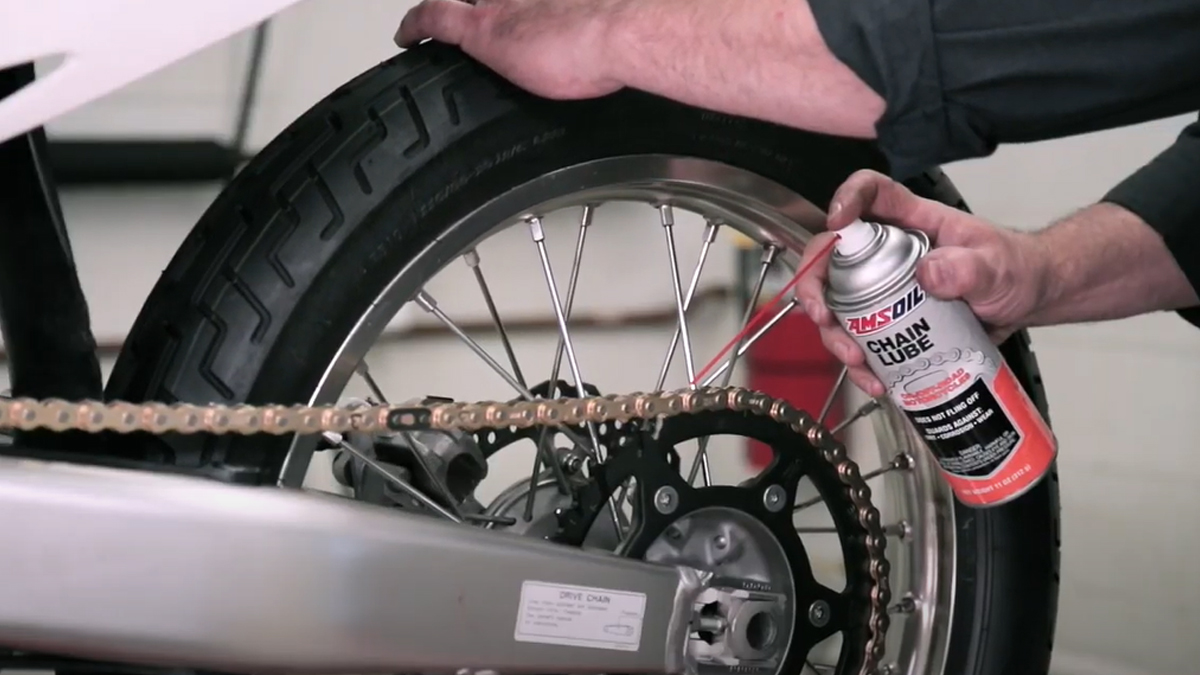 Applying chain lube to a dirt bike chain