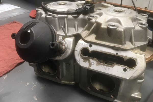 Remove snowmobile exhaust power valve cover