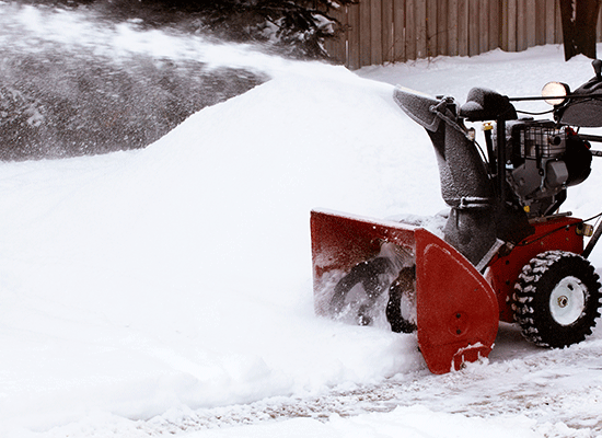 Snowblower clearing driveway