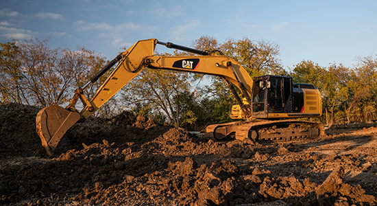 Caterpillar shovel removes dirt.