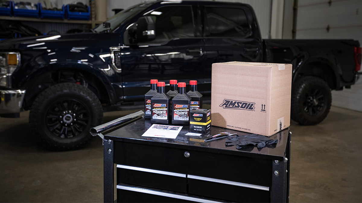 AMSOIL oil-change kit in a garage with a pickup truck.