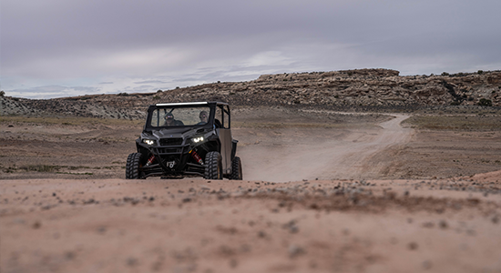 UTV rides a desert trail.