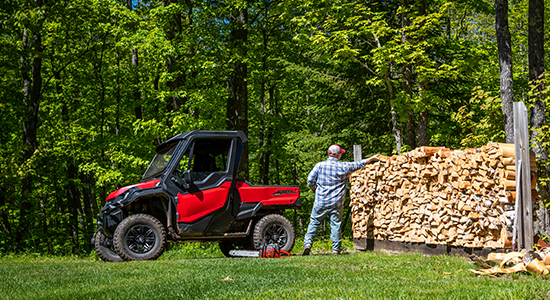 A UTV gets loaded with firewood.