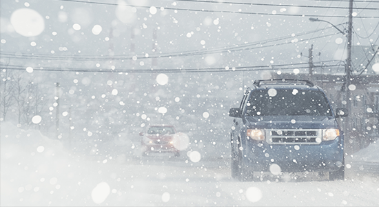 Car on snowy road.