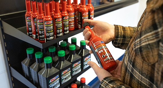 Shelf of AMSOIL products including AMSOIL P.i. gasoline additive.