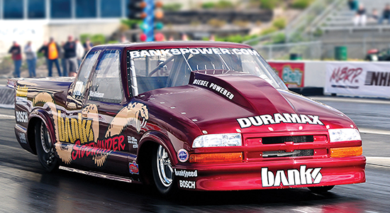 A Banks Power diesel pickup truck makes a run down the quarter-mile track.