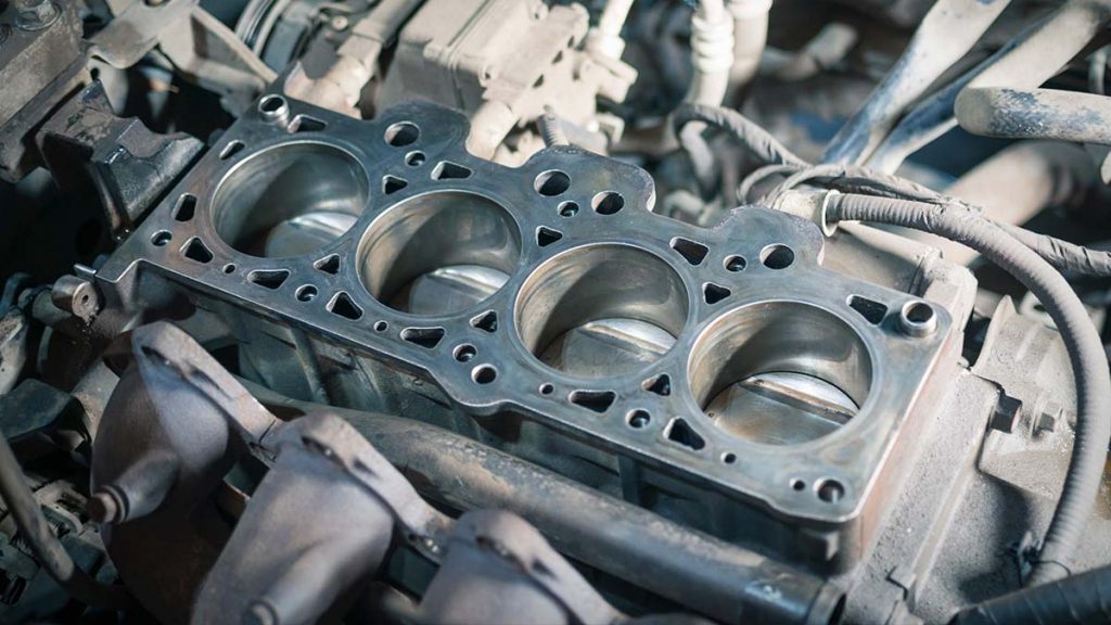 An engine head is open to show where the head gasket is placed.