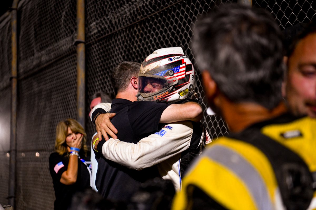 Jimmy Henderson hugs a team member at the fence after clinching the Pro 4 championship